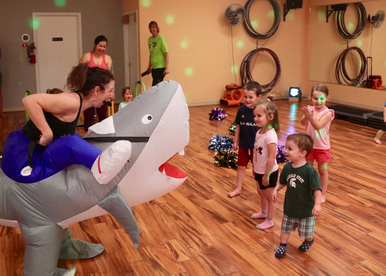 Heather in a shark costume entertaining kids at a movement storytime class